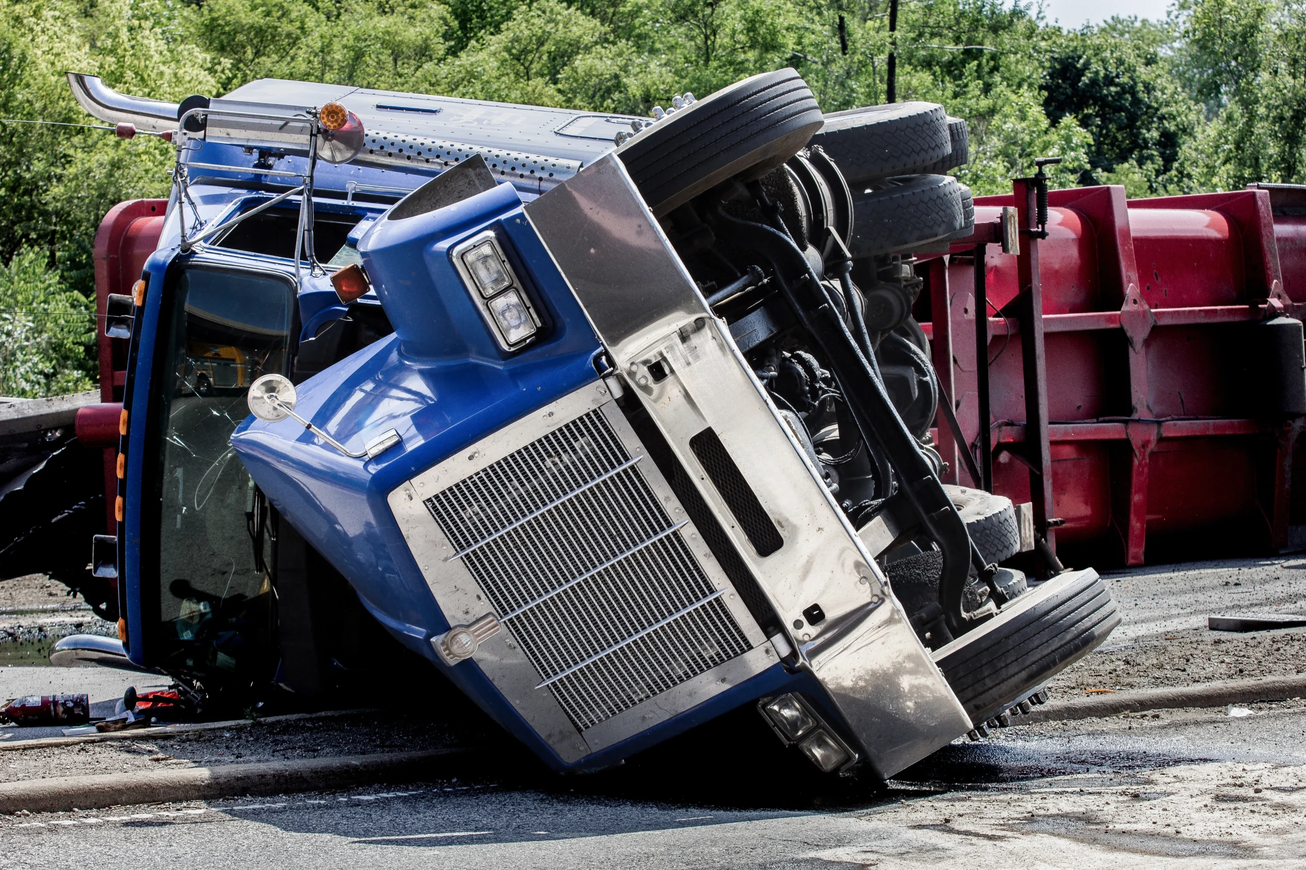 A large truck flipped over on its side.